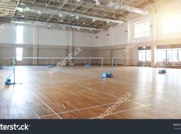 stock-photo-interior-of-empty-badminton-court-610923992