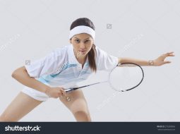 stock-photo-portrait-of-young-female-player-playing-badminton-isolated-over-gray-background-275289065